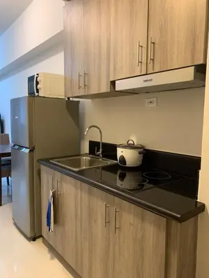 a kitchen with a sink and a refrigerator at SMDC Coast Residences Roxas Boulevard corner Pasay Condo Unit in Manila