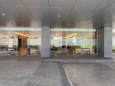 a large glass building with a person standing in front of it at SMDC Coast Residences Roxas Boulevard corner Pasay Condo Unit in Manila
