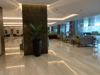 a lobby with a potted plant in the middle of a building at SMDC Coast Residences Roxas Boulevard corner Pasay Condo Unit in Manila
