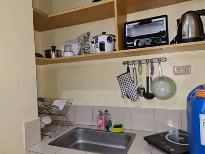 a kitchen counter with a sink and a microwave at Pet Friendly Staycation in in Cainta