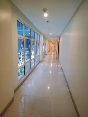 an empty hallway with large windows in a building at 101 Newport Boulevard -Terminal 3 Airport in Manila