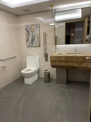 a bathroom with a toilet and a sink at Amour Staycation Shell residences in Manila