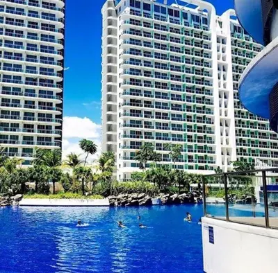 a swimming pool in front of two tall buildings at Azure Beach Resort A5 Near Mall Airport in Manila