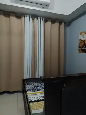 a room with curtains and a bench in front at 5 Years Legit Staycation Infront of Moa, Moa Arena, Smx, Ikea, Sea Residences Tower A Near Dfa Macapagal, NU Moa, PICC, World Trade, Star City, Ayala Mall, Parqal Mall, NAIA 1,2,3 in Manila