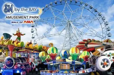 an amusement park with a roller coaster and a ferris wheel at 5 Years Legit Staycation Infront of Moa, Moa Arena, Smx, Ikea, Sea Residences Tower A Near Dfa Macapagal, NU Moa, PICC, World Trade, Star City, Ayala Mall, Parqal Mall, NAIA 1,2,3 in Manila