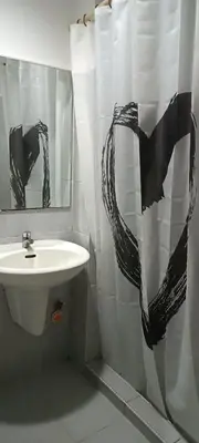 a bathroom with a sink and a shower curtain at 5 Years Legit Staycation Infront of Moa, Moa Arena, Smx, Ikea, Sea Residences Tower A Near Dfa Macapagal, NU Moa, PICC, World Trade, Star City, Ayala Mall, Parqal Mall, NAIA 1,2,3 in Manila
