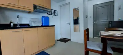 a kitchen with a sink and a counter top at Spacious Studios in Manila