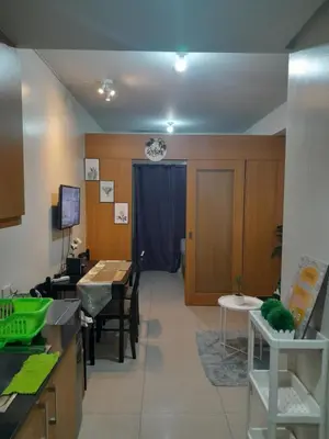 a kitchen with a table and a dining room at vin's place 1br amenities view at Shell Residence in Manila