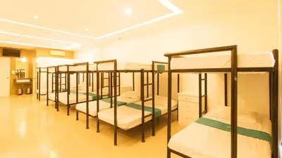 a row of bunk beds in a room at SOUTHPICKRESORT & HOTEL INC. in Aplaya