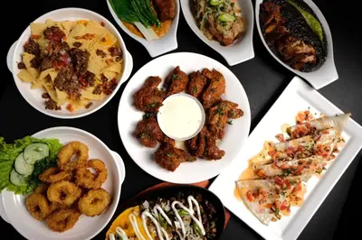 a group of plates of food on a table at SOUTHPICKRESORT & HOTEL INC. in Aplaya