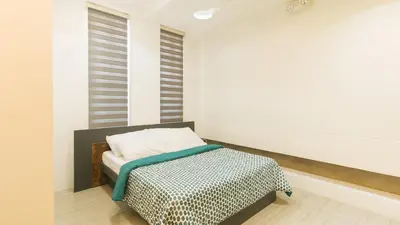 a bedroom with a bed and a window at SOUTHPICKRESORT & HOTEL INC. in Aplaya