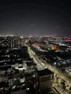 a city lit up at night with cars at SMDC Coast Residences near PICC in Manila
