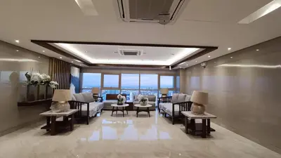 a living room with a couch and chairs and a table at Pasay Coast Residences JCMJ in Manila