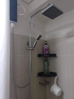 a shower with a shower head in a bathroom at Pasay Coast Residences JCMJ in Manila