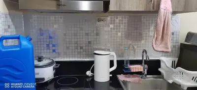 a kitchen with a sink and a counter top at Pasay Coast Residences JCMJ in Manila
