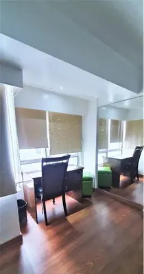 a room with chairs and a table and a piano at 2 BR loft-type condo Fort Victoria in Manila