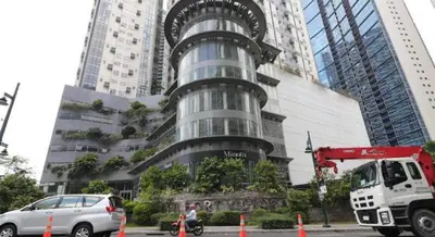 a tall building with a car parked in front of it at 2 BR loft-type condo Fort Victoria in Manila