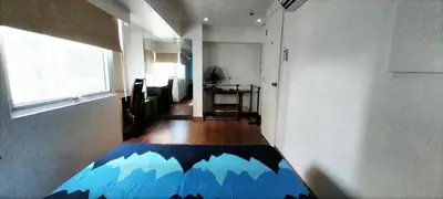 a room with a bed with a mountain design on it at 2 BR loft-type condo Fort Victoria in Manila