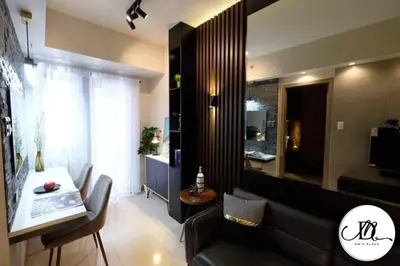 a living room with a couch and a table at DM's Place at S Residences MOA in Manila