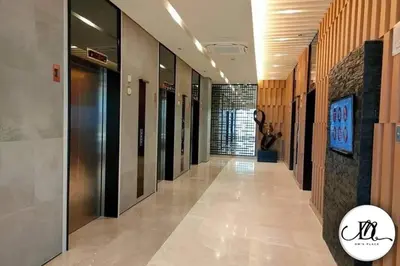 a hallway with many elevators in a building at DM's Place at S Residences MOA in Manila