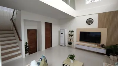 a living room with a tv on a wall at Addie's Place Camella Homes 2D Muntinlupa in Manila