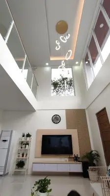 a living room with a flat screen tv and skylights at Addie's Place Camella Homes 2D Muntinlupa in Manila
