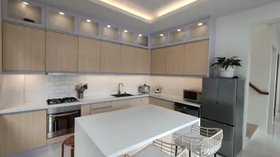 a kitchen with a white table and a black refrigerator at Addie's Place Camella Homes 2D Muntinlupa in Manila