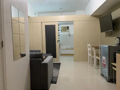 a living room with a couch and a table at Amazing Condo at SMDC Light Residences Boni Avenue Mandaluyong in Manila
