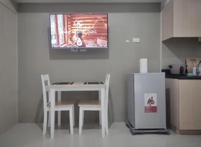 a kitchen with a table and two chairs and a refrigerator at Amazing Condo at SMDC Light Residences Boni Avenue Mandaluyong in Manila