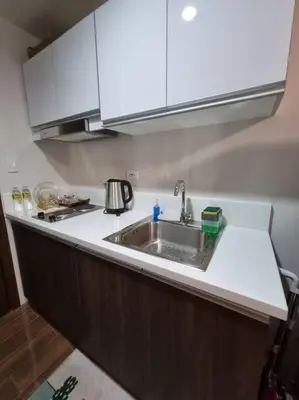 a kitchen with a sink and a counter top at Great View 1 BR Condo in Makati near Trident Tower in Manila