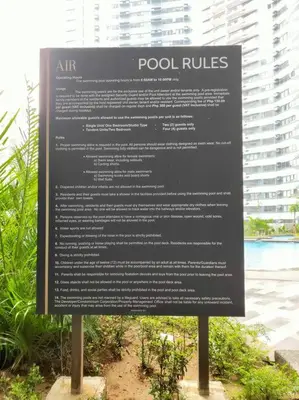 a sign in front of a building at Great View 1 BR Condo in Makati near Trident Tower in Manila