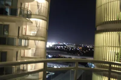 a view of a building and a parking lot at night at Azure Urban Resort Residence A3 in Manila