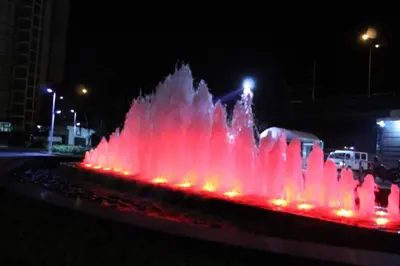 a fountain with red lights in a city at night at Azure Urban Resort Residence A3 in Manila