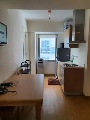 a kitchen with a table and a kitchen with a window at Azure Urban Resort Residence A3 in Manila