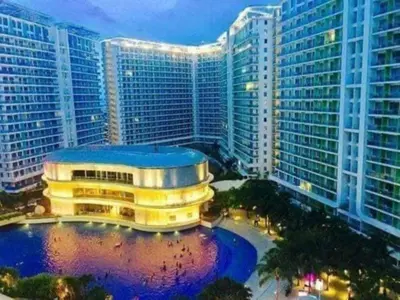 a building in front of a city with tall buildings at Azure Urban Resort Residence A3 in Manila
