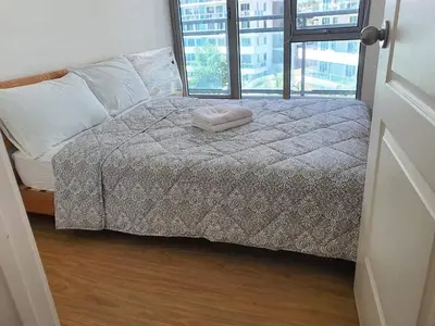 a bed in a room with a large window at Azure Urban Resort Residence a2 in Manila