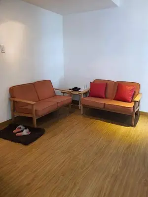a room with two couches and a table with red pillows at Azure Urban Resort Residence a2 in Manila