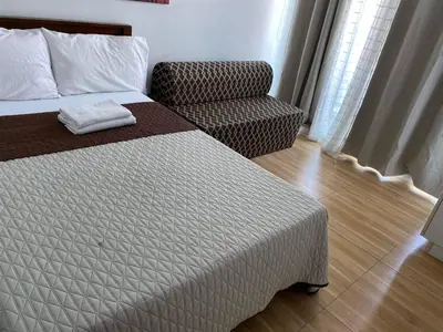 a hotel room with a bed and a chair at Azure Urban Resort Residence a2 in Manila
