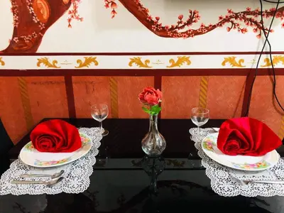 a table with two plates with red napkins on top at Azure Urban Resort Residence A1 in Manila