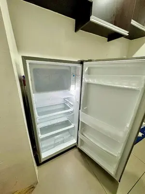 an empty refrigerator with its door open in a kitchen at 2BR w Balcony in Araneta, Cubao w Pool and Gym - Porto Vita in Manila