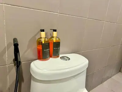 two bottles of alcohol sitting on top of a toilet at 2BR w Balcony in Araneta, Cubao w Pool and Gym - Porto Vita in Manila