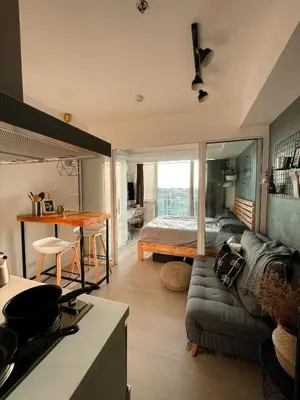 a living room with a couch and a bedroom at Downtown Nook - Azure Urban Resort Residences in Manila