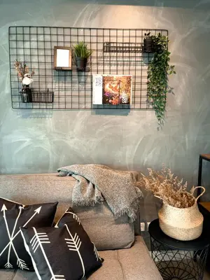a living room with a couch and plants on a wall at Downtown Nook - Azure Urban Resort Residences in Manila