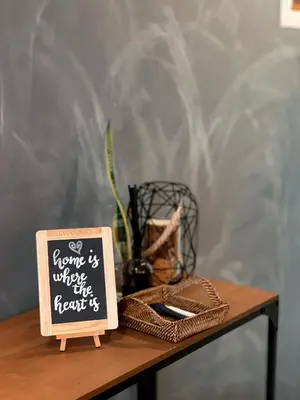 a wooden table with a sign on top of it at Downtown Nook - Azure Urban Resort Residences in Manila