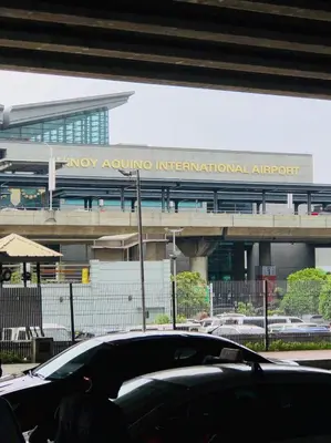 a car driving on a road in front of an airport at THE MANSION - NEAR AIRPORT BIG FAMILY Lodge in Manila