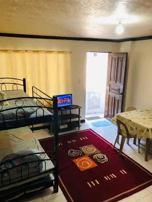 a room with two bunk beds and a rug at THE MANSION - NEAR AIRPORT BIG FAMILY Lodge in Manila