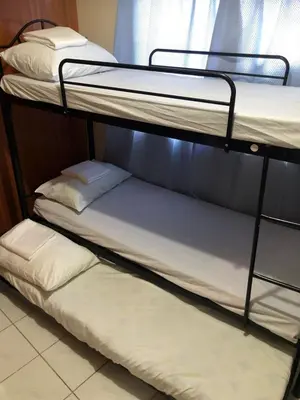 two bunk beds in a room with a window at THE MANSION - NEAR AIRPORT BIG FAMILY Lodge in Manila