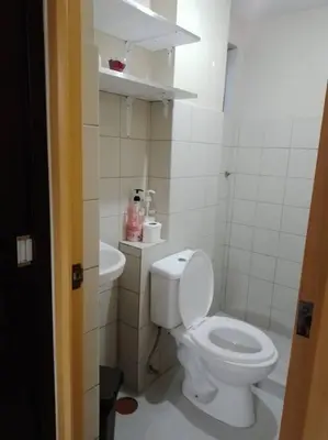 a bathroom with a white toilet and a sink at Affordable Transient along Ortigas Ext in Cainta