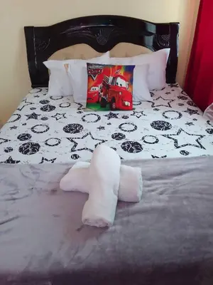 a bed with a pile of towels on it at Budget Friendly Condo for Rent in Valley Mansions in Cainta