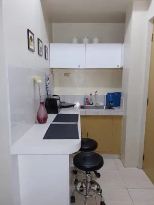 a kitchen with a counter and two stools at Budget Friendly Condo for Rent in Valley Mansions in Cainta